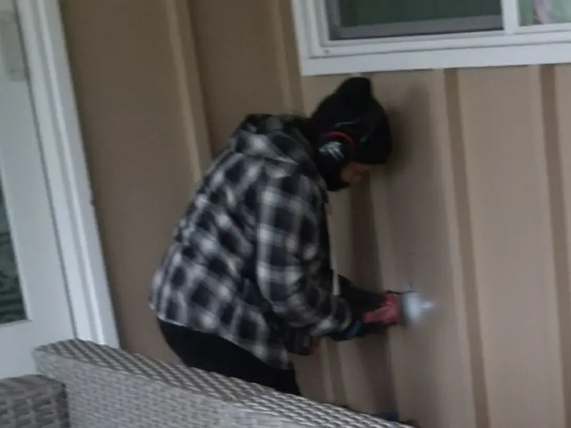 Professional electrician installing an exterior outlet in Mulvane